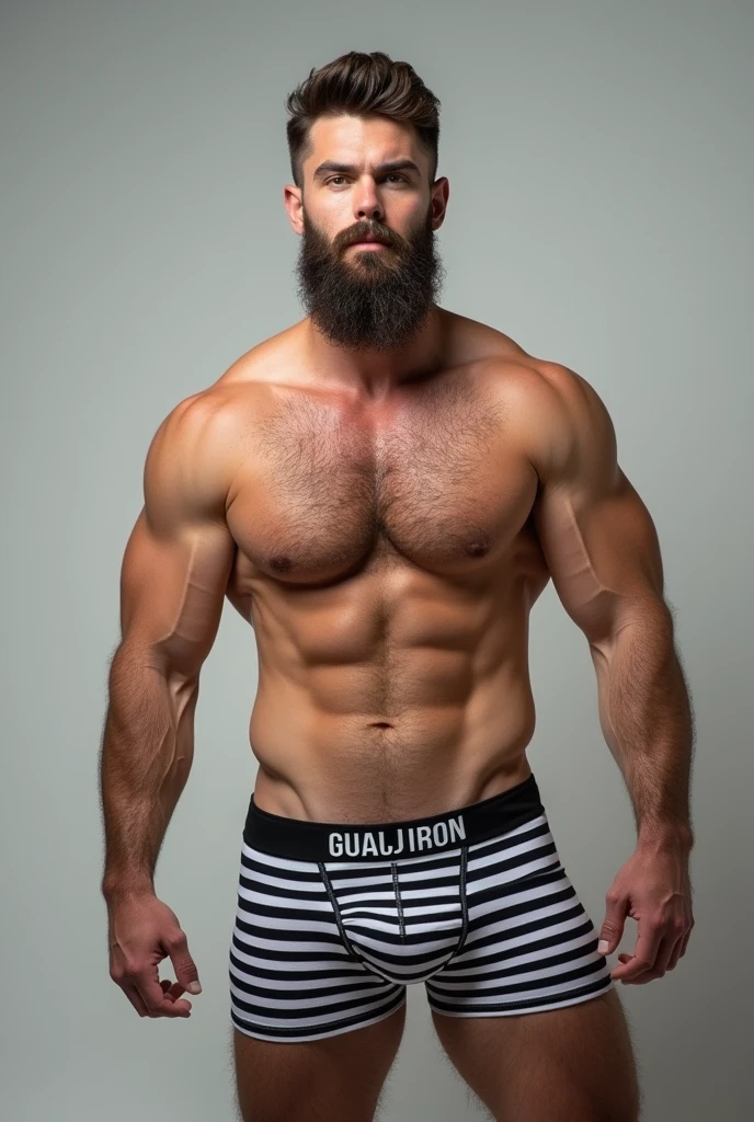 Color image of a strong, bearded young Caucasian man wearing black and white striped underwear, written in capital letters “GUAJIRO” non-elastic.