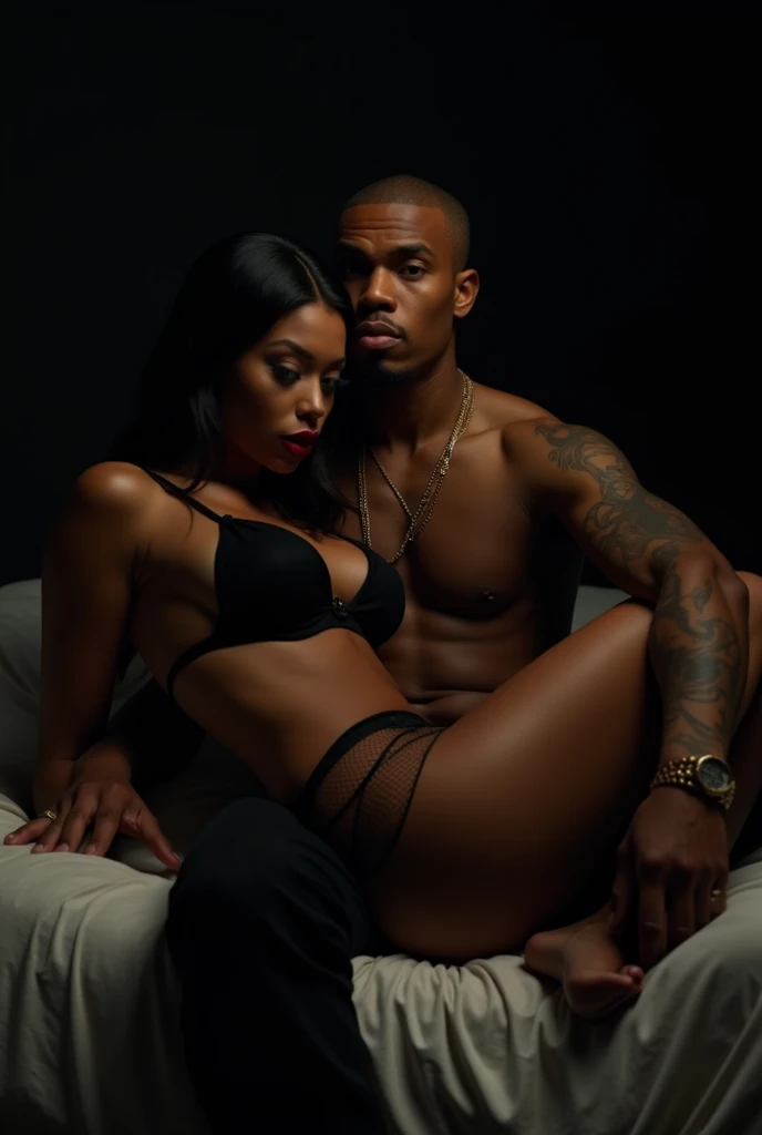 Chris Brown sitting on the bed with black woman in his lap. She’s wearing lingerie. Pitch black background.