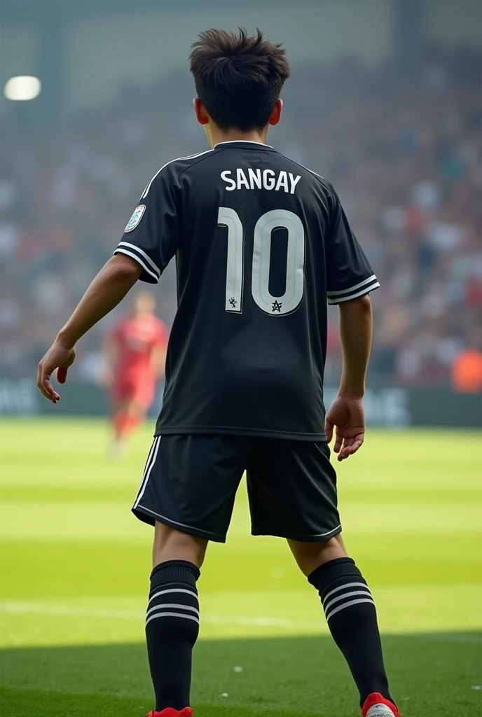   Footballer with name SANGAY and also with jersey 10 from back view with black shirt in ground with white color in Jersey and name showing style with white half pant
