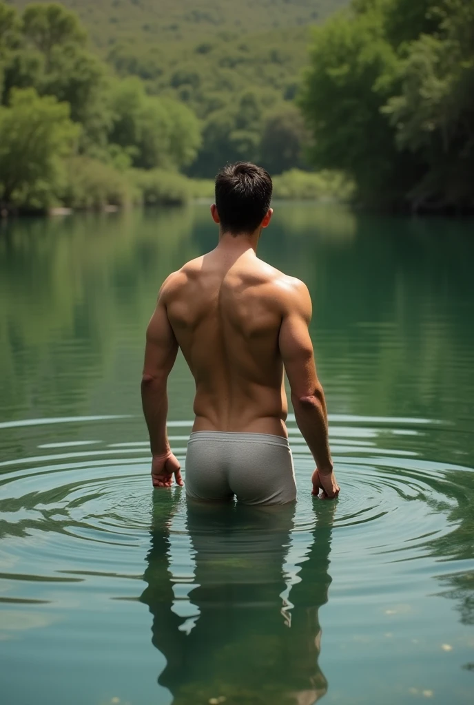 A white man, at 3, model type, with short dark hair, with clear eyes, wearing a full shirt and boxers, standing backwards, looking at the camera and showing her ass in a lake in Alentejo