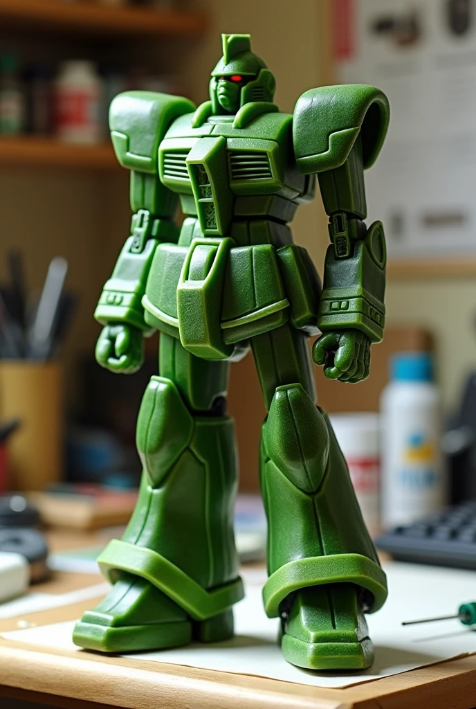 A plastic model Gundam made from a cucumber is placed on top of the desk. Tools are in the background
