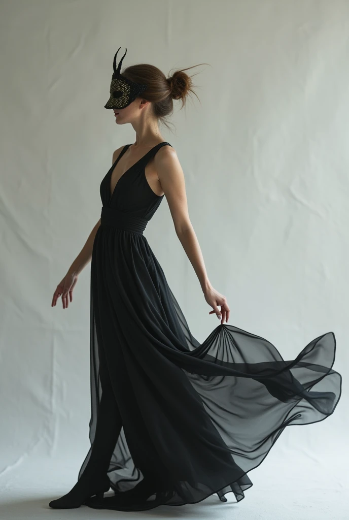 A woman related to theatrical art with a mask and a long dress with a light gray background young woman doing rehearsal movements