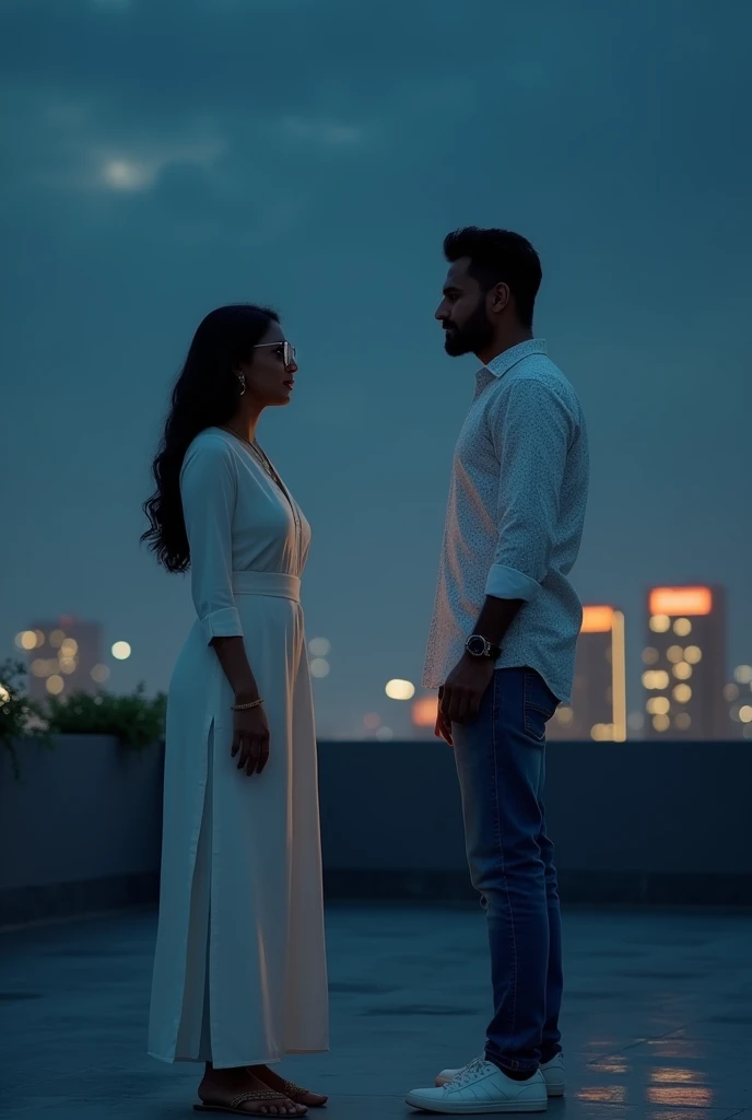 A woman and a men are talking on the rooftop at night, the women is wearing a white Indian traditional suit and glasses, the men is wearing a white printed shirt, jeans and white shoes.