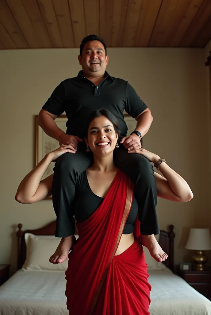 Beautiful and Slim Indian woman Aishwarya Rai in black blouse red saree , lifting a large chubby man above her shoulders, man is sitting on woman's shoulders, natural smile, in a bedroom with high ceiling at night