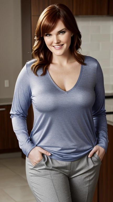 Sara Rue wearing a long-sleeved shirt with a neckline and plain pants and smiling