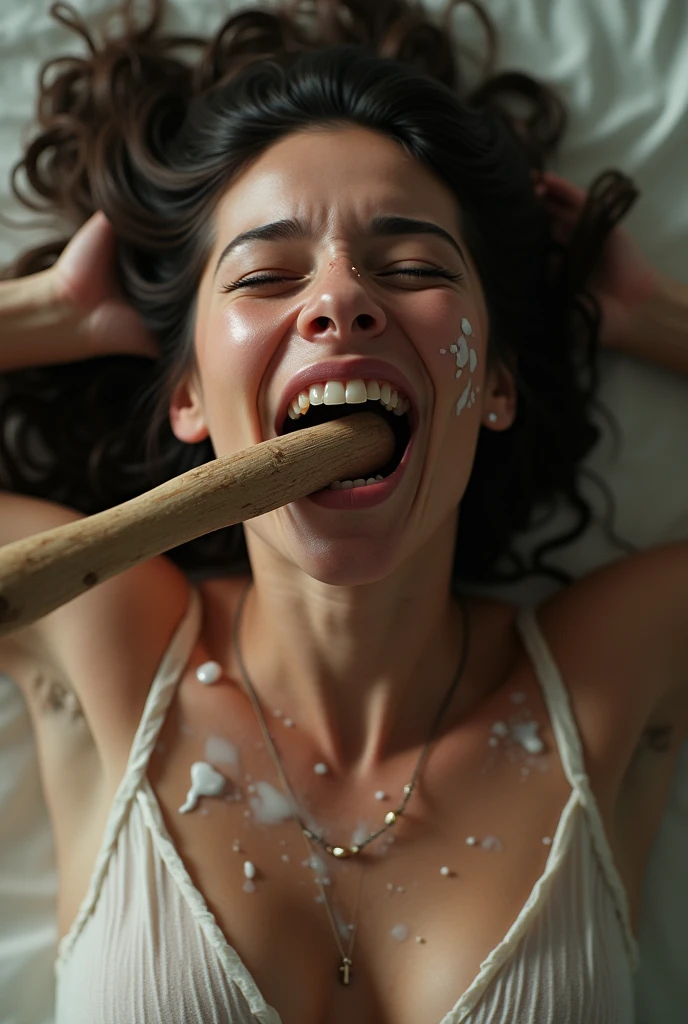 A woman seen from above, just the face and part of his body, kneeling, mouth open feeling great pleasure with orgasm expressions, she has milk splashes on her face, with a thick wooden handle in the mouth