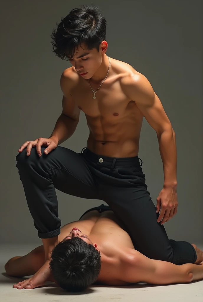 A sexy shirtless boy wearing fit pants sitting on the top of the belly of a lying guy while placing feet on his face