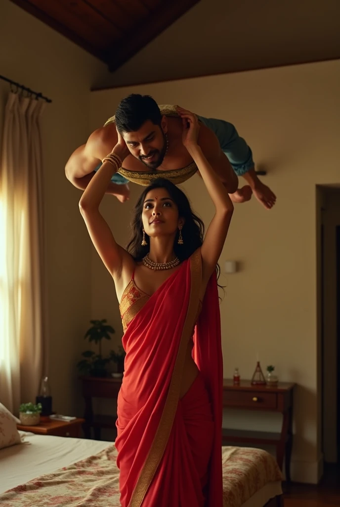 Beautiful and Slim Indian woman Ileana D'Cruz in red silk saree , lifting a large chubby man above her shoulders, man is sitting on woman's shoulders, natural smile, in a bedroom with high ceiling at night