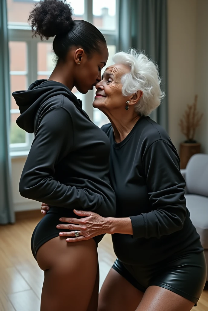 black woman hair in a bun black hoodie black leather short shorts bent over and old woman grabbing her cheeks and kissing her neck living room