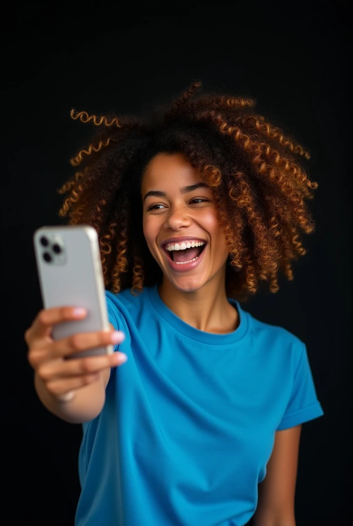 The image shows a young women with curly hair, smiling and holding up a smartphone ahead . She is wearing a blue t-shirt and appears to be happy and excited. The background is black 