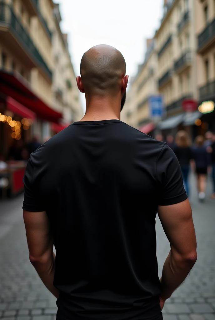 create a realistic photo of a bald man in Paris. he is completely turned away, you can't see his face, of costs for a camera, wearing a chic basic black t-shirt