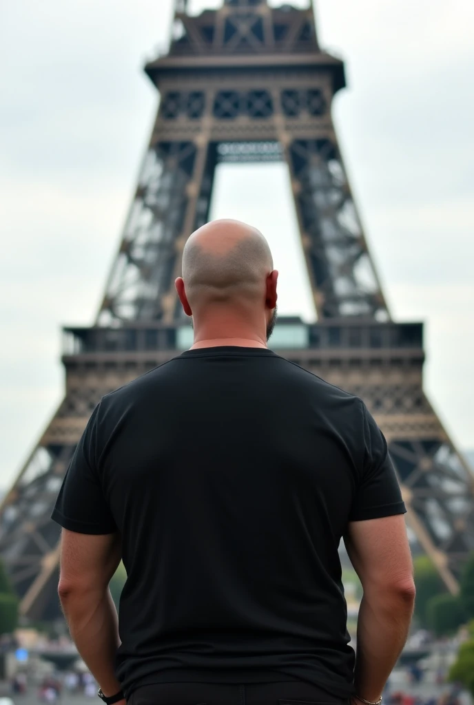 create a realistic photo of a bald man in Paris. showing the Eiffel Tower, he is completely turned away, you can&#39;t see his face,  of costs for a camera, wearing a chic basic black t-shirt. He is stocky and a little chubby and not muscular and white in color