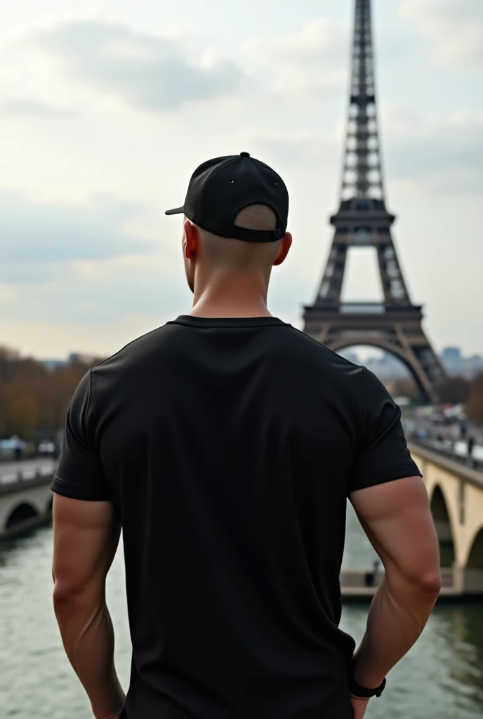 use this last created photo already with ( an ultra modern realistic image of a bald man in Paris. he is completely turned away, you can&#39;t see his face,  facing away from the camera, wearing a chic basic black t-shirt.  white in color and the tower away from the full body photo ) just add a black backwards cap to it
