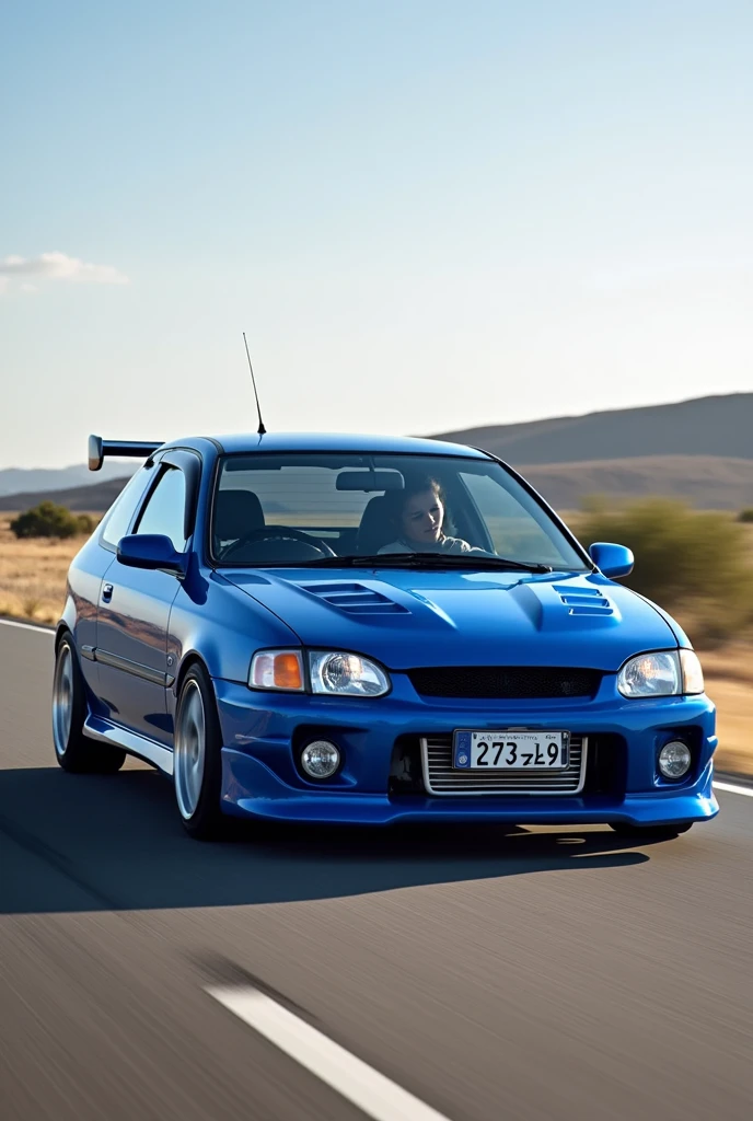 A 1999 toyota starlet glanza V with airflow in the color bleu and plate number ( 2793 ZL 99 ) on the road