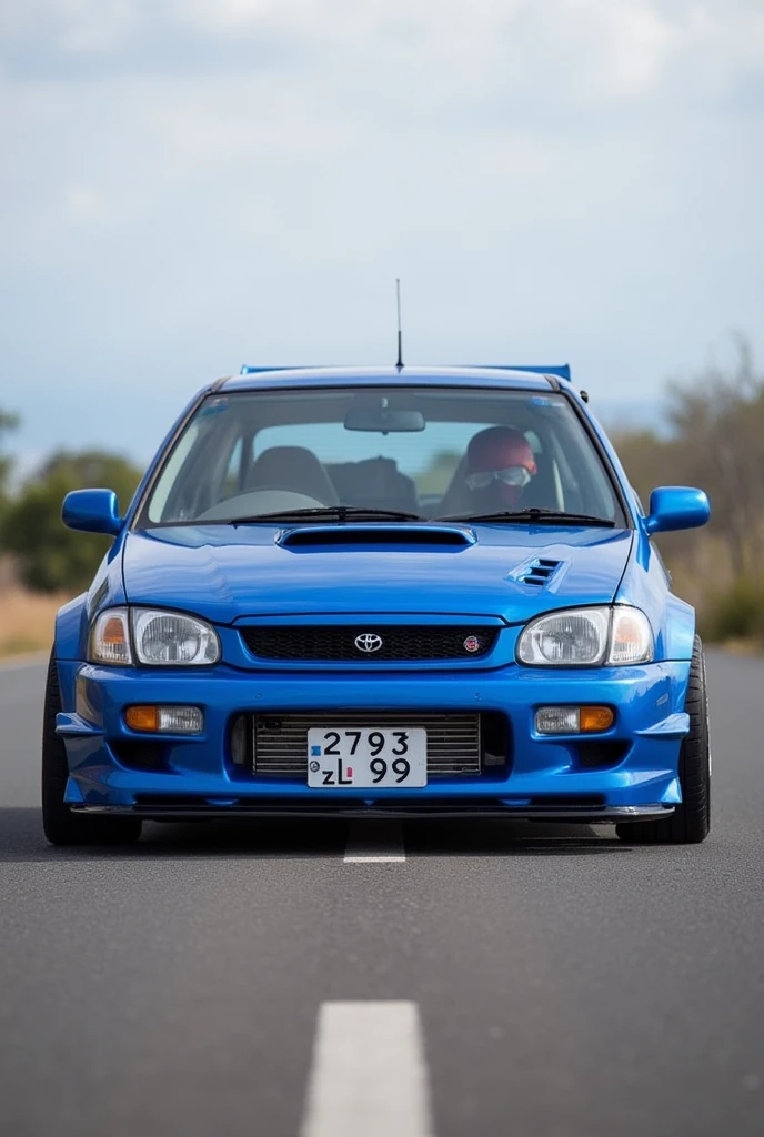 A 1999 toyota starlet glanza V with airflow in the color bleu and plate number ( 2793 ZL 99 ) on the road