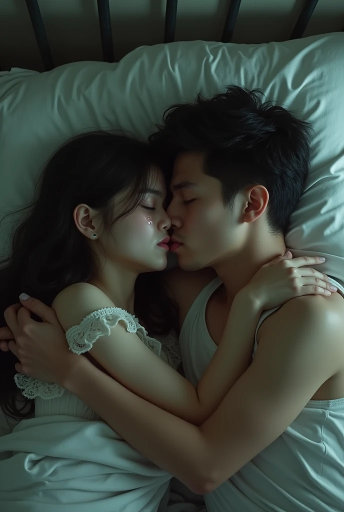 Beautiful girl kissing boy on bed with tears on her eyes