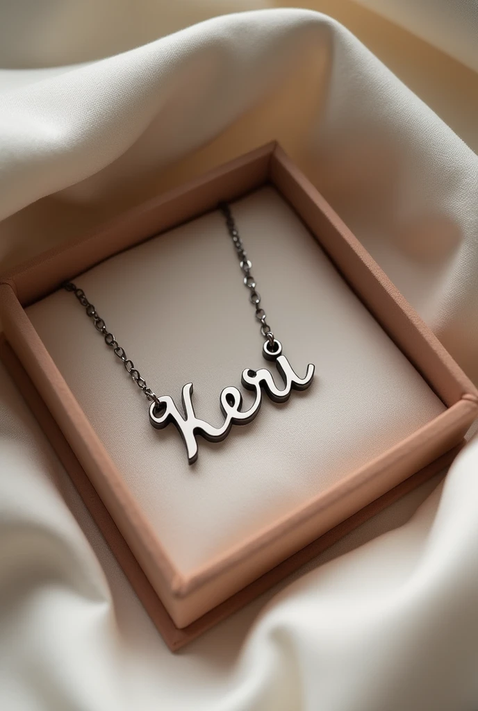 a silver necklace that says the name kerii in a cursive font in a necklace box on a bed