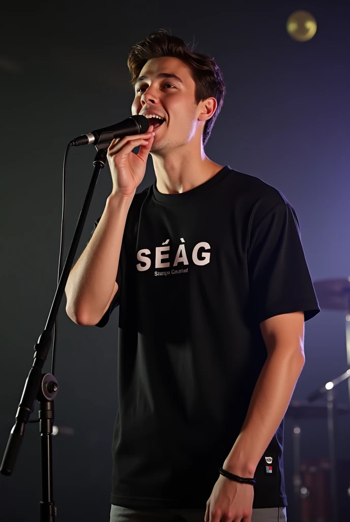 A handsome with slight long hair boy singing Infront of mic wearing black t-shirt written SEAG on it