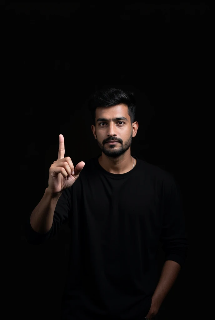 The image shows a man wearing a black shirt, is pointing upwards with his index finger. The background is black