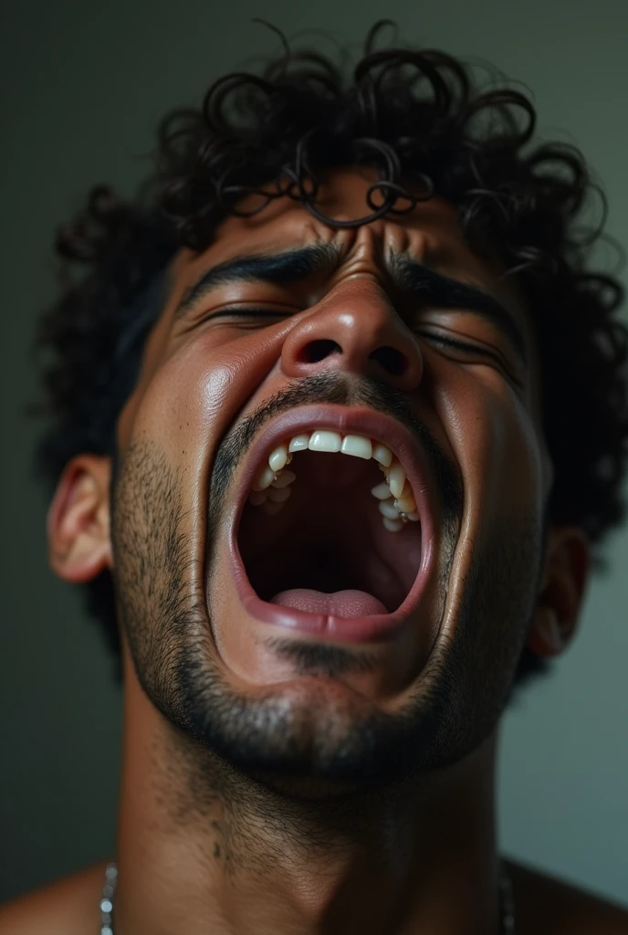 Young man with brown skin crying loudly