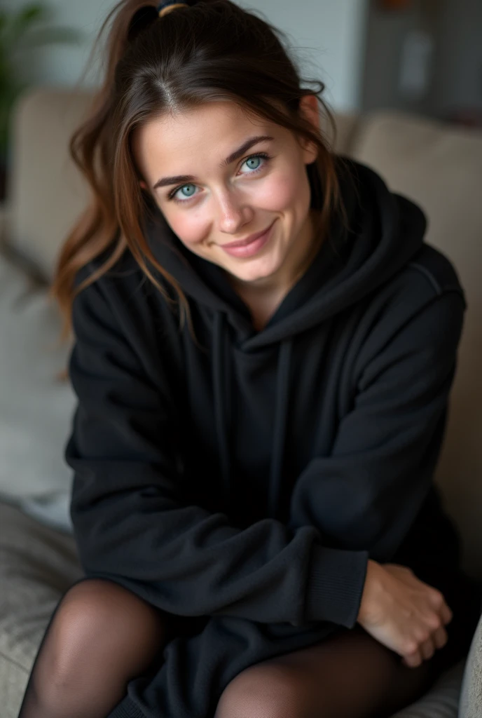 dark brown hair、pulled back ponytail、teaing smile、 she wears a black hoodie.、black pantyhose、adult german woman、blue eyes、showing her black pantyhose、sitting on a couch、young german woman、wide angle、 she has ocean blue eyes.、