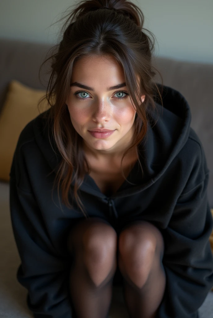 dark brown hair、pulled back ponytail、teaing smile、 she wears a black hoodie.、black pantyhose、adult german woman、blue eyes、showing her black pantyhose、lying on a couch、young german woman、wide angle、 she has ocean blue eyes.、
