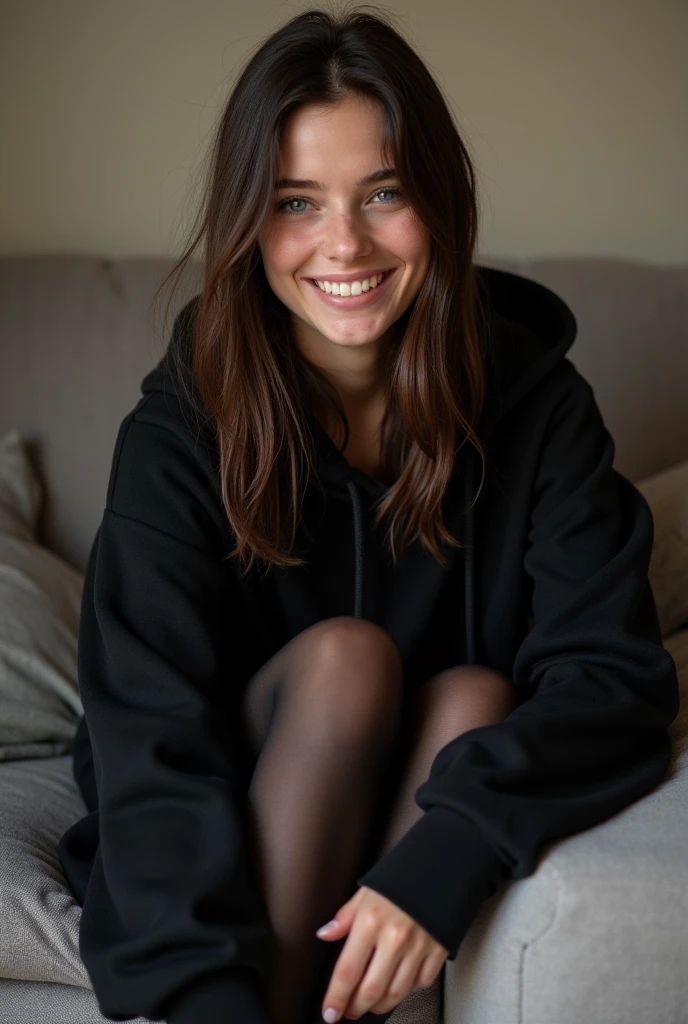 dark brown hair、straight hair、full body 、teaing smile、 she wears a black hoodie.、black pantyhose、adult german woman、blue eyes、showing her legs 、lying on a couch、young german woman、wide angle、 she has blue eyes.、