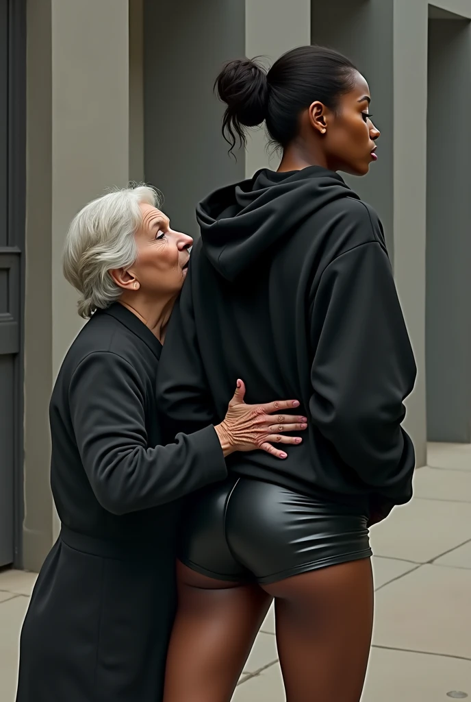 black woman hair in a bun black hoodie black leather short shorts rea;;y in shock as a old grandma in a dress on her knees kissing her ass behind her hand is in her ass holding her ass