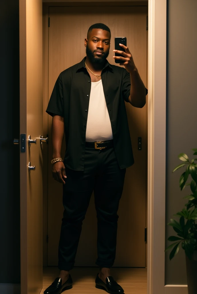 disposable camera shot of a lean muscular handsome Dark Skinned young big Black man, a short beard fade, very short haircut, wearing a black slightly unbuttoned tucked in short sleeve bowling shirt, white tank, belt, gold bracelet, black chino pants, with black luxury penny loafers, at night, standing, taking a closet door mirror selfie in his modern apartment