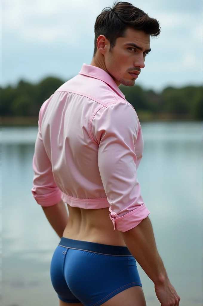 A white man, aged 35, model type, with short dark hair, with blue eyes, wearing a full white and pink shirt and blue boxers, from sideways, looking at the camera and showing her ass in a lake in Alentejo