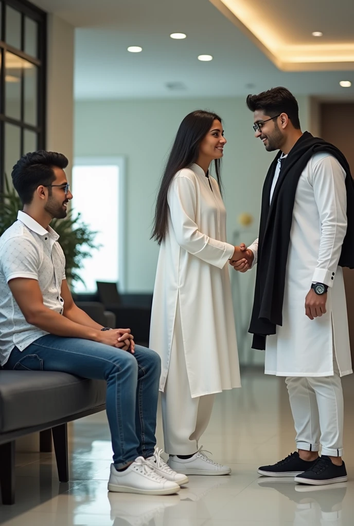 Two young men are waiting for their girlfriends in the reception area of the office. One of the young men is wearing a white printed shirt, jeans, white shoes and smart watch and the other is wearing a white full sleeve t-shirt, jeans, glasses and black sneakers. His girlfriend comes there wearing a white Indian suit, black pallu, white shoes and glasses. Then she shakes hands with both the boys.