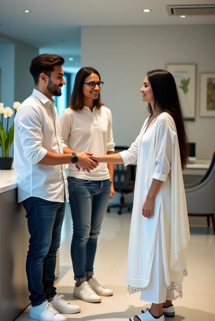 Two young men are waiting for their girlfriends in the reception area of the office. One of the young men is wearing a white printed shirt, jeans, white shoes and smart watch and the other is wearing a white full sleeve t-shirt, jeans, glasses and black sneakers. His girlfriend comes there wearing a white Indian suit, black pallu, white shoes and glasses. Then she shakes hands with both the boys.