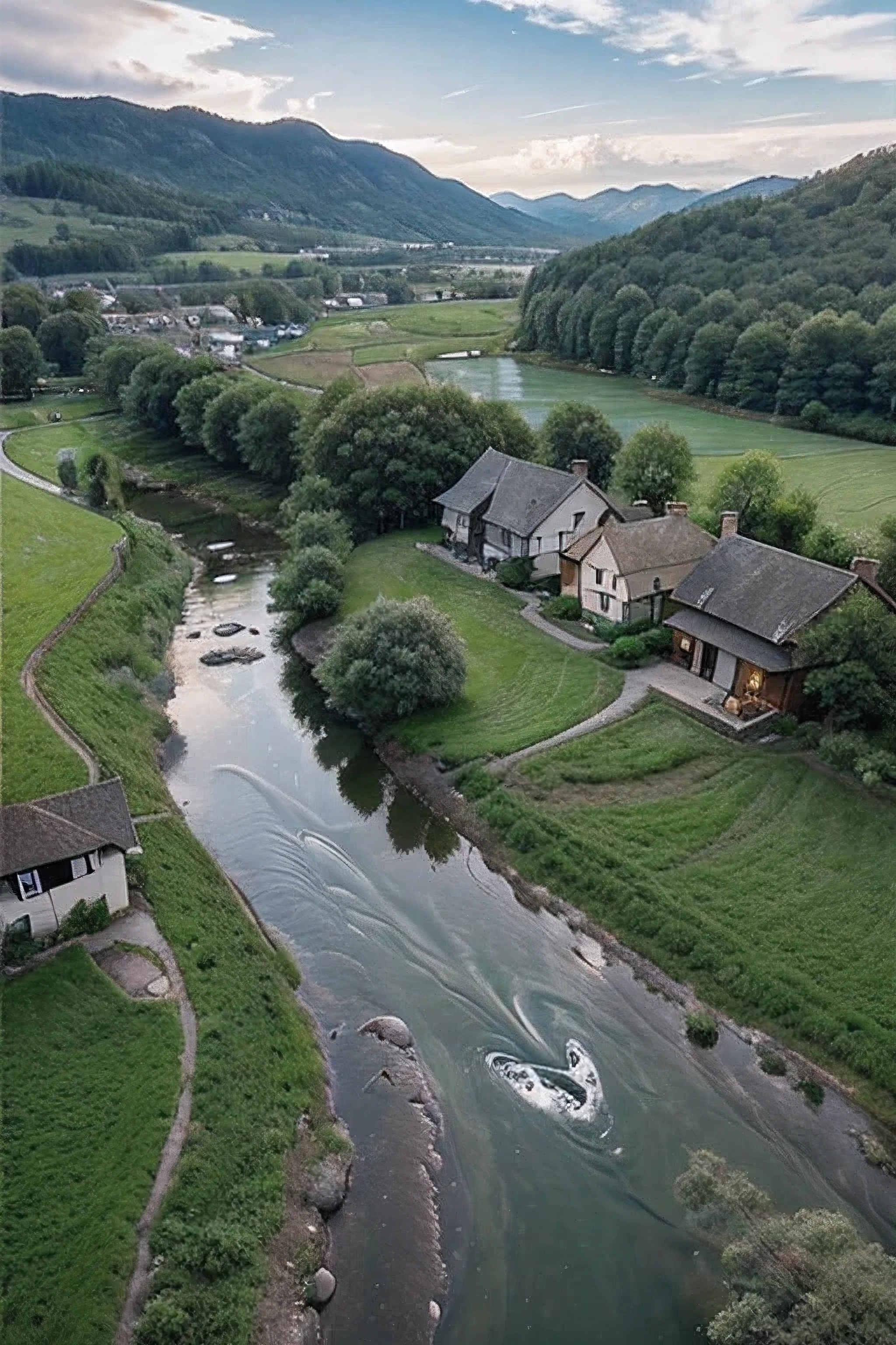 A serene drone view of a picturesque valley with a gentle stream of water flowing through it. The stream winds between small, charming houses scattered across the landscape. In the foreground, children are playing joyfully, some splashing in the shallow water while others run across the green meadows. The houses are quaint, with sloped roofs and vibrant colors, nestled among tall trees. The overall scene is peaceful and idyllic, capturing a moment of simple joy and natural beauty from an aerial perspective."