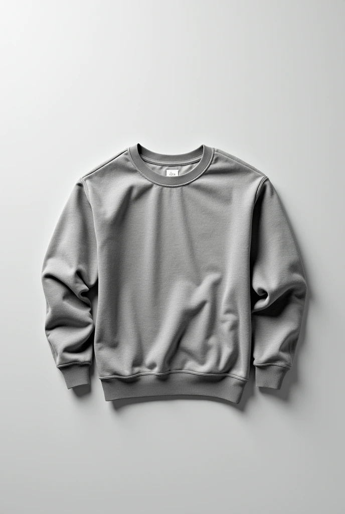 A piece of clothing, a gray round-neck sweatshirt, is laid flat on the table and folded up