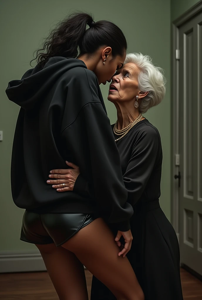 black woman hair in pigtails black hoodie shiny black leather short shorts pockets in shock as a old grandma in a dress on her knees kissing her ass behind her hand is in her ass holding her ass backside view french kissing love making