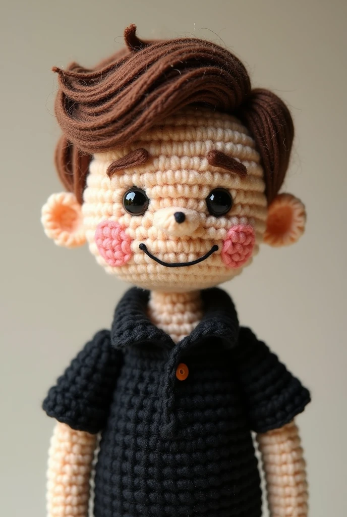 A male crochet doll, mole on the right side of the face between the nose and mouth, short highlighted hair and black polo shirt