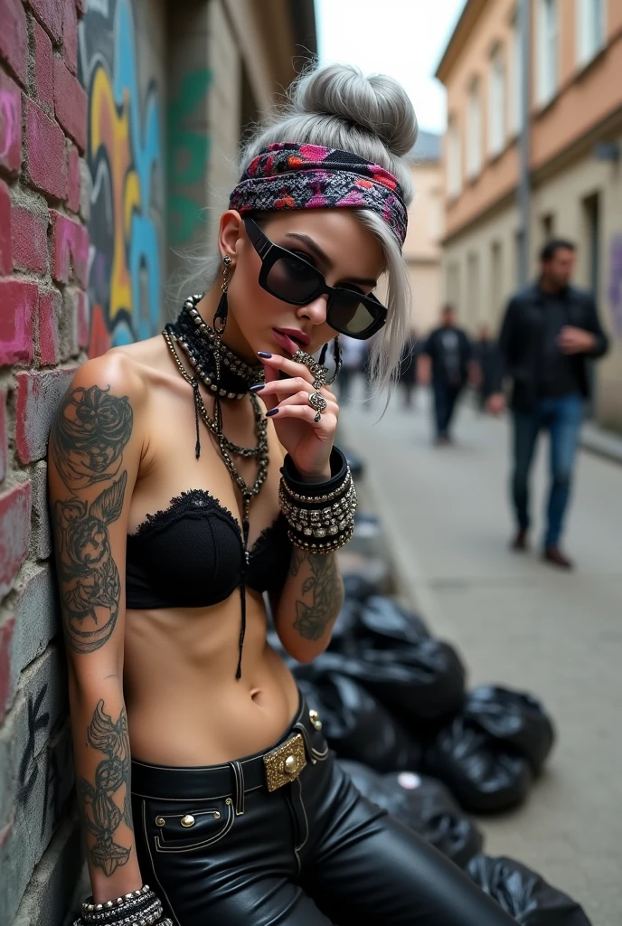 russian woman, grey hair (bouffant, top bun) and oversized square sunglasses and wide colourful bandana as headband, with very light green eyes, extremely pale. Big lips. Black lace push up bra, silicone breaight skinny black low rise leather jeans. Light pink high heel mules. Lots of thick wide studded bracelets, chain necklaces and big rings,. Two loose studded belts. Long earrings with chains and feathers. Leaning her back against a graffitied wall, separated legs, touching her lip and neck. Chin down in shame, looking down at the ground, Neck, chest, stomach and wrists heavily tattoed. Toned abdominals, thin neck, slim legs and thin arms. Narrow hips. Full body. At a dead end street with graffitied walls, ground littered with waste and piled black plastic garbage baSome men in the background. Full body, frontal view