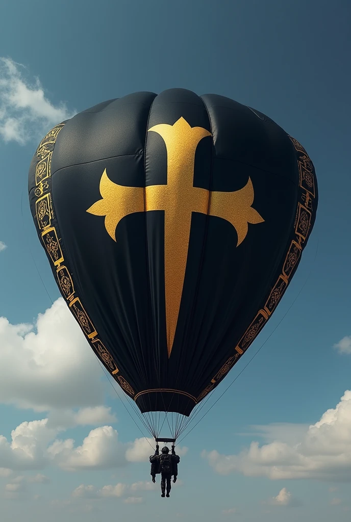 Black parachute with a large gold print of the symbol "THE HERO" At the center. Decorative tribal patterns along the edges.