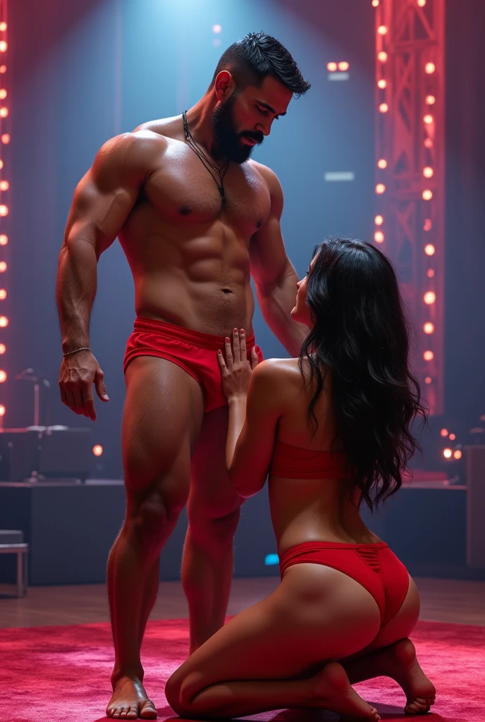 A young Puerto Rican man hairy bearded strong muscular red underwear bulge bulge, having his open underwear pulled down by a beautiful woman in red panties crouching in front of him, in performance on a stage of a television program presented by a famous presenter.