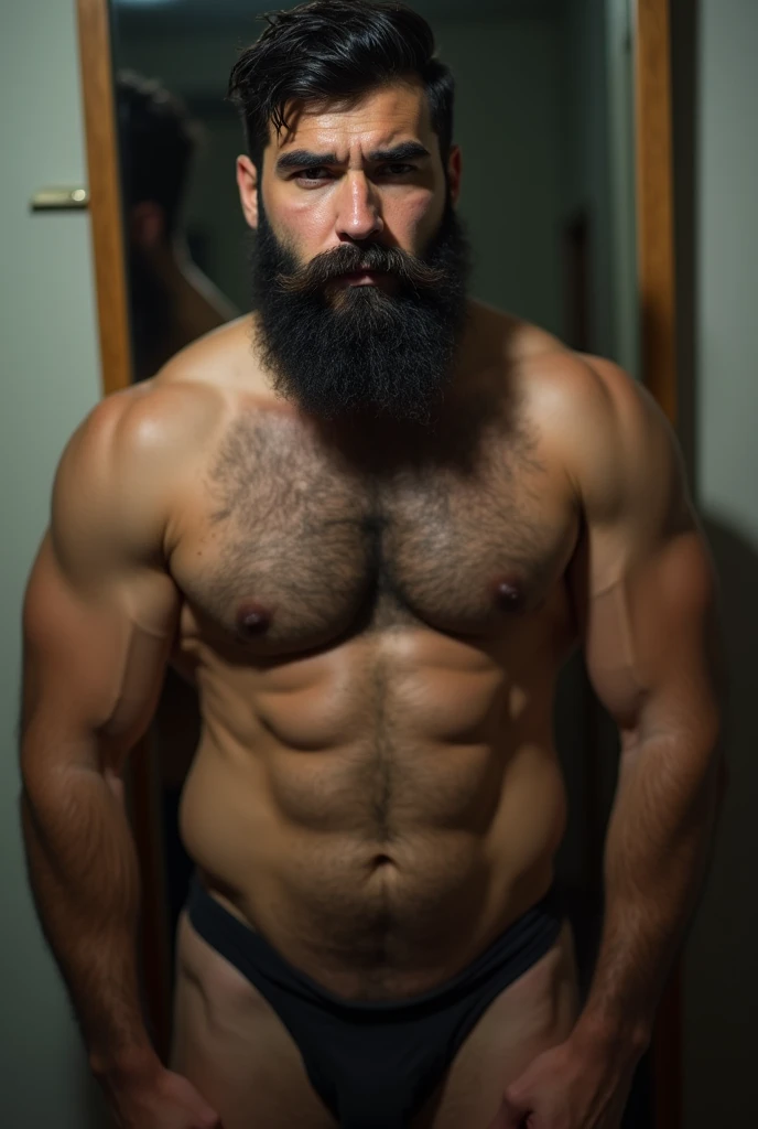 Strong hairy bearded young Iranian man in front of mirror without clothes naked naked from hips up, hairy groin, top showing.