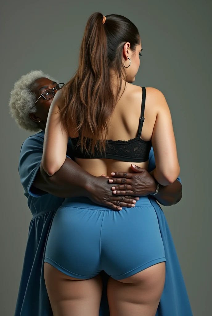 Create a photo of a 30 year old young woman, with a slender and beautiful body, wearing blue gym shorts and black lace bra, with white and clear skin, with long light brown hair, wearing hoop earrings stands with her back to the camera as she is lifted high by the waist by an obese black 90-year-old woman, dark black skinned, who has short hair, who wears glasses and a blue dress