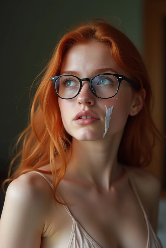 A completely naked teenage redhead in glasses on her knees in front of me looking up at me after giving me fellatio so I can see her beautiful face, her huge tits and can see her round plump ass as I look over her shoulder. She has a large amount of gooey clear/white semen all over her face and tits and is biting her lip, desperate to lick it all off of herself so she can get some more. 