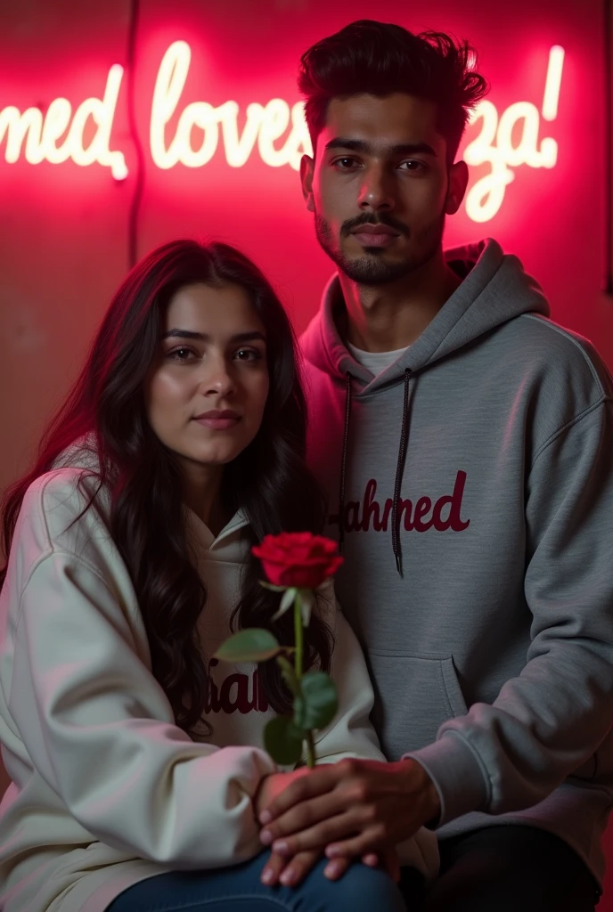 A 8K detailed portrait ultra HD qulaity of a 27 years slim smart, handsome guy from pakistan and a beautiful pakistan's 30-years woman in white hoodies. "Dx-Ahmed" is on his hoodie, "Fiza" on hers. She holds a red rose while sitting, with a neon-lit wall behind them reading "Dx-Ahmed loves Fiza." The mood is romantic and serious.
