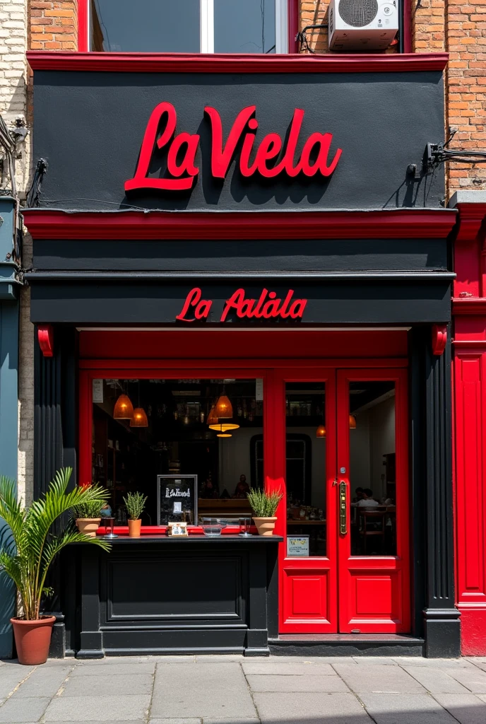 Facade of a black and red kebab shop named La Viela in a community