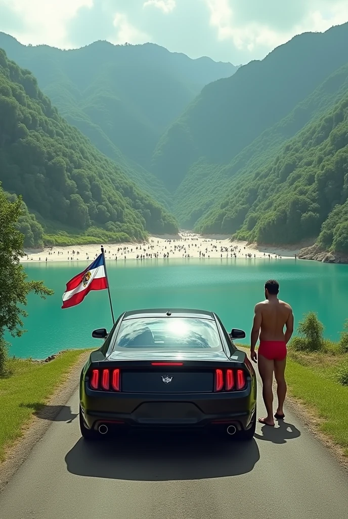 Black car stopped at the end of a paved road that ends in a large lake with water on all sides, panoramic view, lots of green and white sand beach with lots of people. Man in red underwear next to car. Flag of the State of El Salvador raised.
