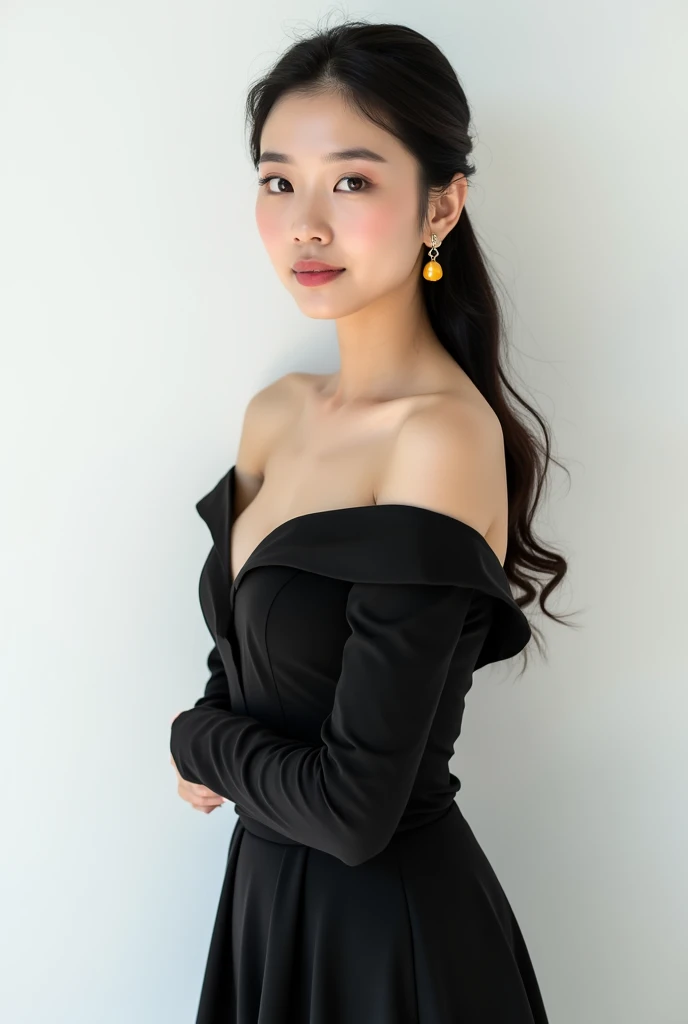 Beautiful Asian woman wearing classic dark dress with open shoulders. Three quarter portrait on white background. Straight posture. She wears beauty amber earrings.