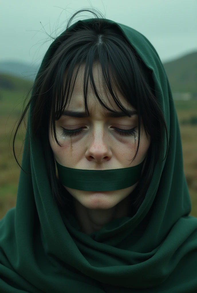Sad woman. Sad face. Crying. Hills background.  Tape on mouth. No blood on face.  Little green dark