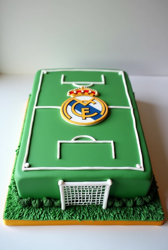 Rectangular cake with a football field theme and the Real Madrid logo in the middle