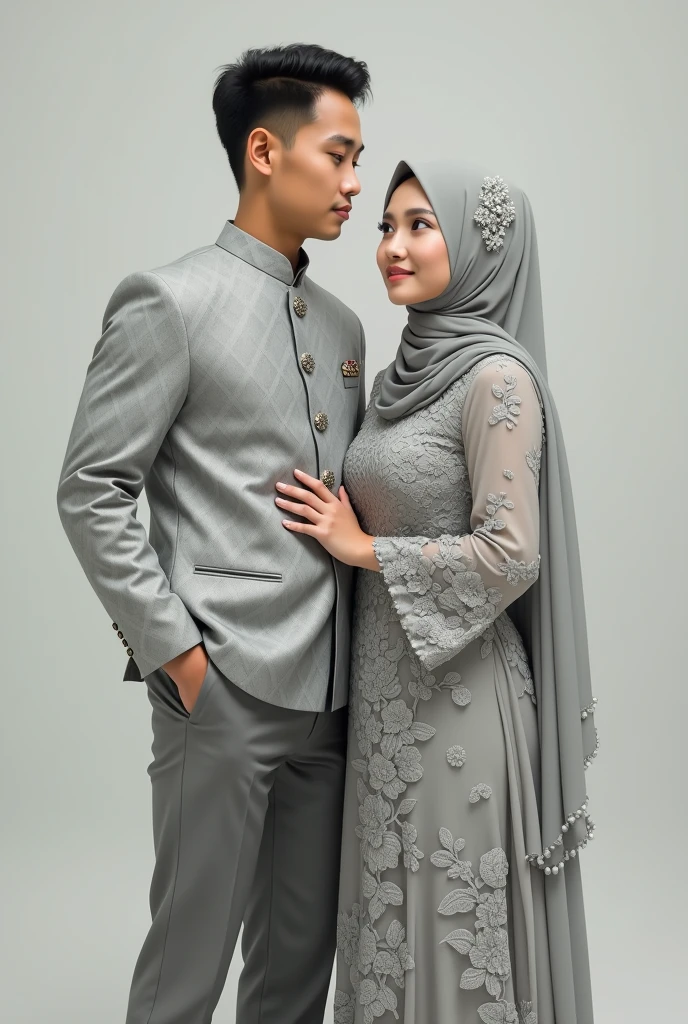 A strong man wearing a short songket coat with a diamond flower pattern in light gray color and slacks in gray color together with a Muslim woman wearing a flowery dress made of light gray lace fabric and a long pom pom veil covering the chest