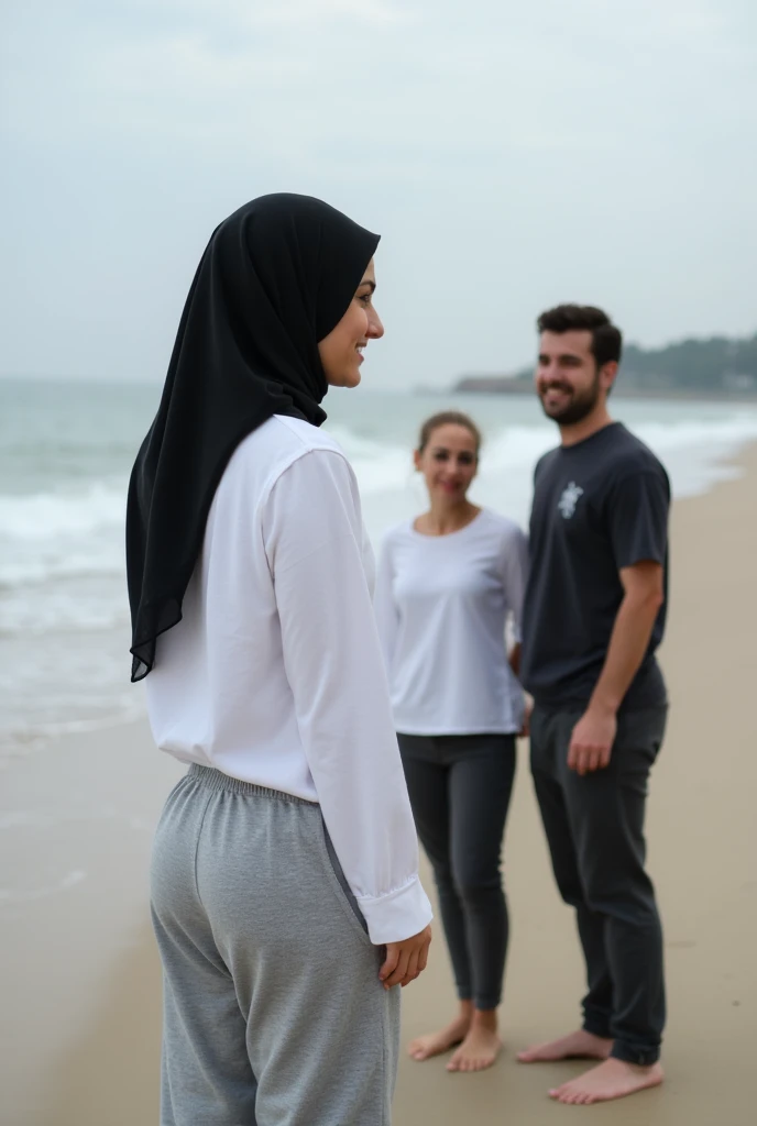 with black headscarf, white long sleeve t shirt, grey sweatpants, Barefoot woman talking with friends on the beach.